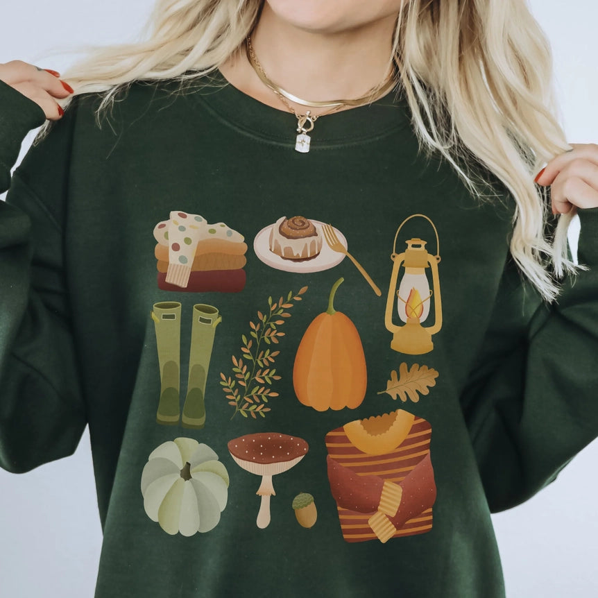 Dunkelgrüner Herbstpullover mit buntem Kürbis- und Herbstmotiv an einer Person getragen